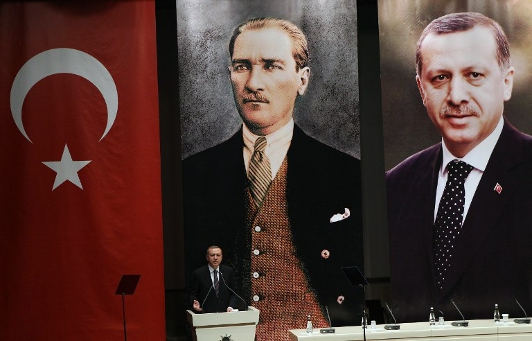 Turkey's then prime minister Recep Tayyip Erdogan delivers a speech in front of posters of himself and Mustafa Kemal Ataturk, the founder of modern Turkey, at a meeting of the ruling AKP party in Ankara on June 25, 2014 Turkey's then prime minister Recep Tayyip Erdogan delivers a speech in front of posters of himself and Mustafa Kemal Ataturk, the founder of modern Turkey, at a meeting of the ruling AKP party in Ankara on June 25, 2014