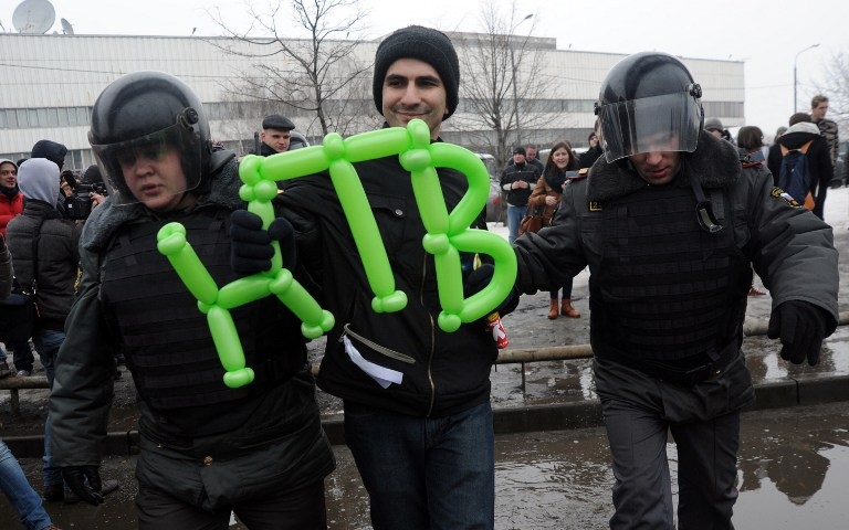 Russian riot police detain an opposition supporter carrying the letter of the NTV television channel at a protest rally in front of the broadcasting center in Moscow on March 18, 2012 Russian riot police detain an opposition supporter carrying the letter of the NTV television channel at a protest rally in front of the broadcasting center in Moscow on March 18, 2012