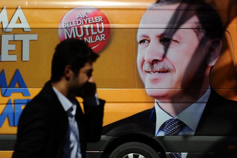 A Turkish man talks on the phone in front of a poster of Recep Tayyip Erdogan in Istanbul on March 21, 2014, after the then premier said he would eradicate Twitter in response to corruption allegations targeting his inner circle A Turkish man talks on the phone in front of a poster of Recep Tayyip Erdogan in Istanbul on March 21, 2014, after the then premier said he would eradicate Twitter in response to corruption allegations targeting his inner circle