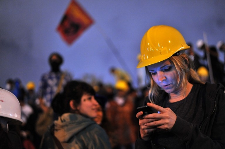 A Turkish woman reads the news on social media as she joins demonstrators at midnight in Taksim Gezi Park on June 13, 2013 in Istanbul A Turkish woman reads the news on social media as she joins demonstrators at midnight in Taksim Gezi Park on June 13, 2013 in Istanbul