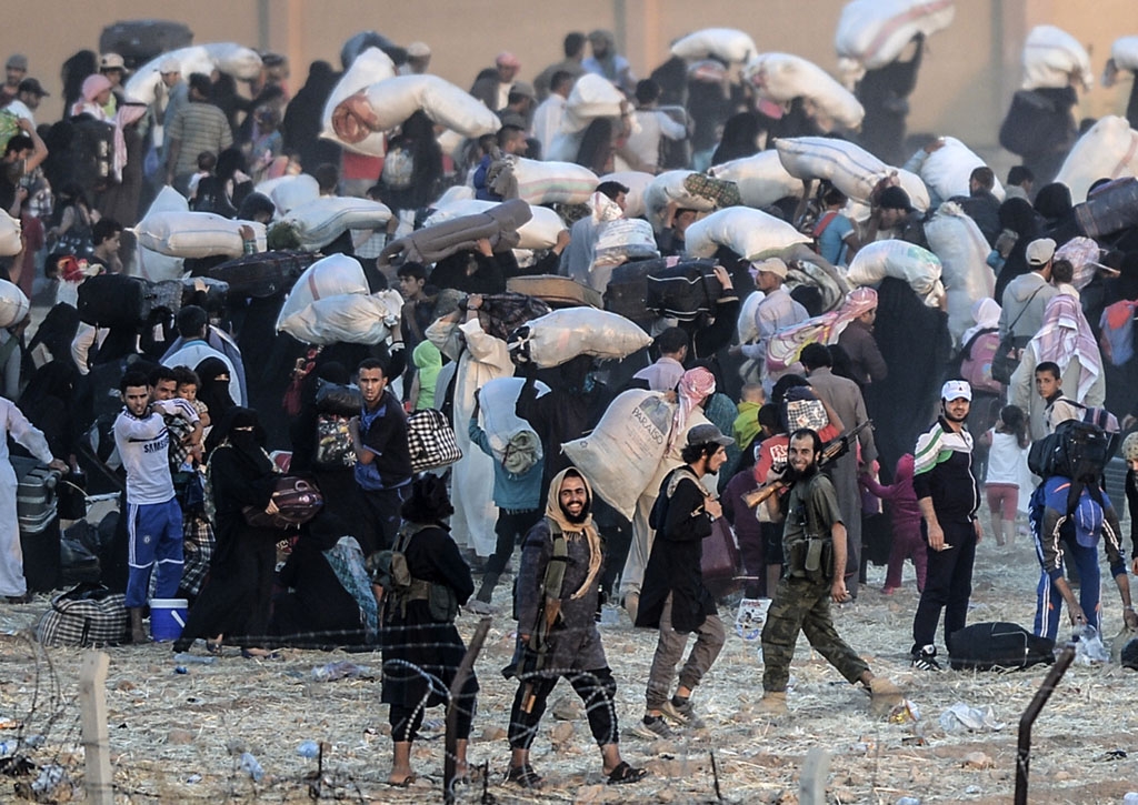 Islamic State fighters ask people to leave the Akcakale border crossing with Turkey on June 13, 2015 Islamic State fighters ask people to leave the Akcakale border crossing with Turkey on June 13, 2015