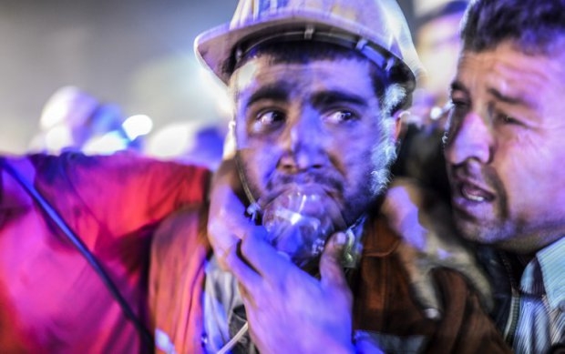 A miner recovers alongside his father after emerging from the Soma mine A miner recovers alongside his father after emerging from the Soma mine
