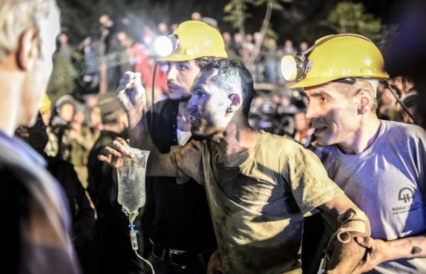 A miner is helped by his friends in Soma on May 13, 2014 A miner is helped by his friends in Soma on May 13, 2014