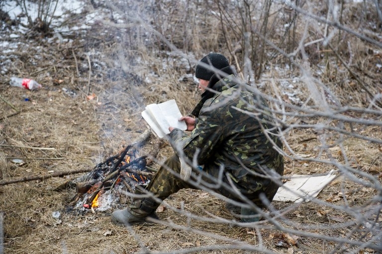 An Ukrainian soldier reads a book during a ceasefire in Svitlodarsk on February 15, 2015 An Ukrainian soldier reads a book during a ceasefire in Svitlodarsk on February 15, 2015