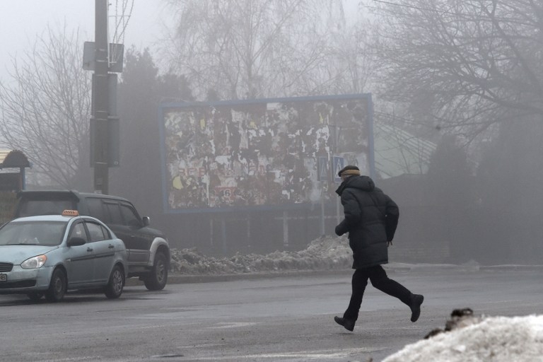 A man runs for cover in Donetsk's Kyibishevsky district, on January 30, 2015 A man runs for cover in Donetsk's Kyibishevsky district, on January 30, 2015