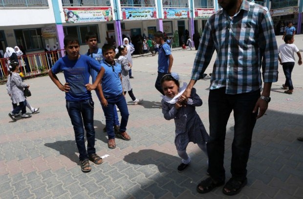 A six-year-old Palestinian girl cries in the playground as she refuses to stay at a United Nations school in Khan Yunis, in the southern Gaza Strip, on September 14, 2014 A six-year-old Palestinian girl cries in the playground as she refuses to stay at a United Nations school in Khan Yunis, in the southern Gaza Strip, on September 14, 2014