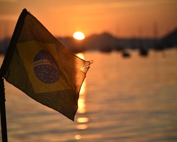 The Brazilian flag flys at sunrise on the  Botafojo beach in Rio de Janeiro during the 2014 FIFA World Cup football tournament on June 25, 2014