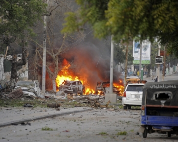 This picture taken on June 1, 2016, shows a car bruning after a terror attack at the Ambassador Hotel, after Somalia's Al-Qaeda-linked Shabaab, launched a deadly attack on a top Mogadishu hotel popular with MPs, setting off a car bomb and fighting securit