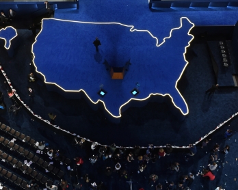 A man walks off an empty stage after Democratic presidential nominee Hillary Clinton did not arrive to speak during election night at the Jacob K. Javits Convention Center in New York on November 9, 2016. 
