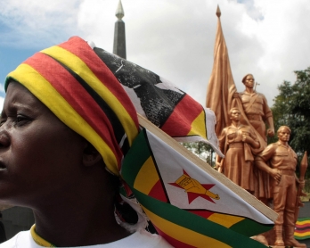 A supporter of Zimbabwean President Robert Mugabe's ruling ZANU-PF attends the funeral of Harare Governor David Karimanzira at the National Heroes Acre in Harare on March 27, 2011.