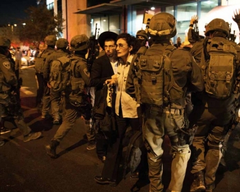 Israeli security forces at the site of a knife attack near the central bus terminal in Jerusalem. (AFP/Menahem Kahana)