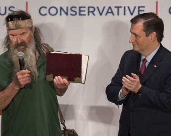 Reality TV's Duck Dynasty star Phil Robertson (L) holds his bible as he endorses Republican presidential candidate Ted Cruz during a campaign rally in Charleston, South Carolina, February 19, 2016 (AFP / JIM WATSON)